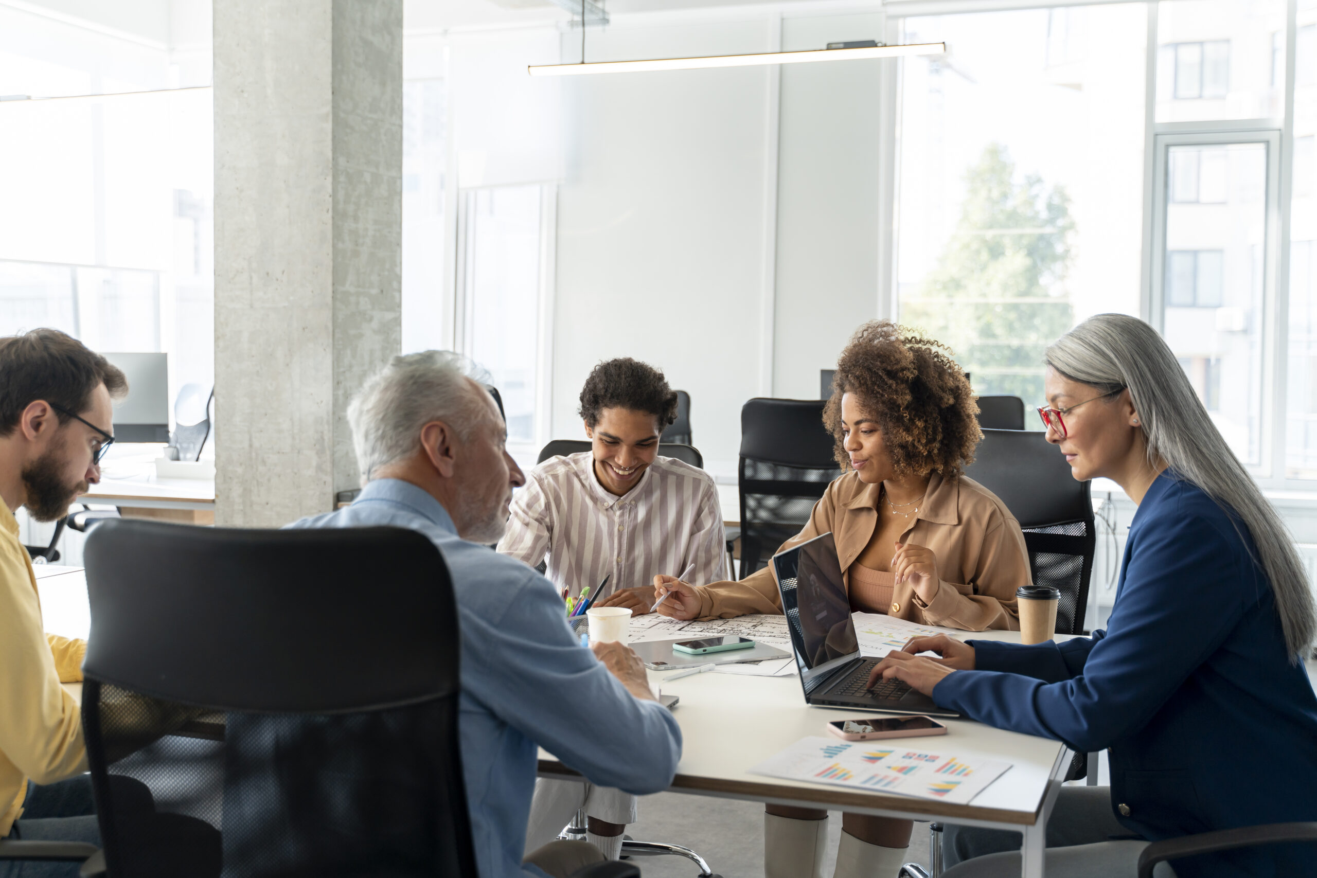 Adults at a table with work